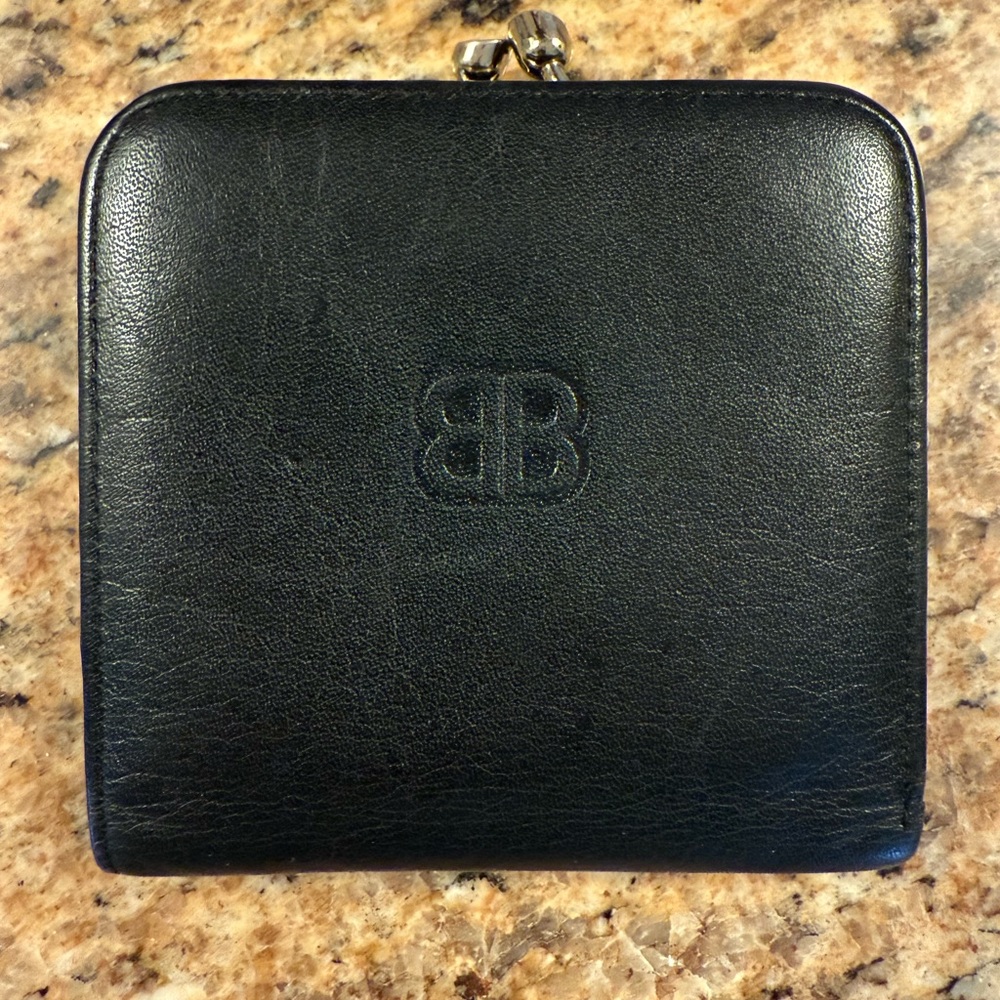 Black Balenciaga kiss lock wallet with snap.